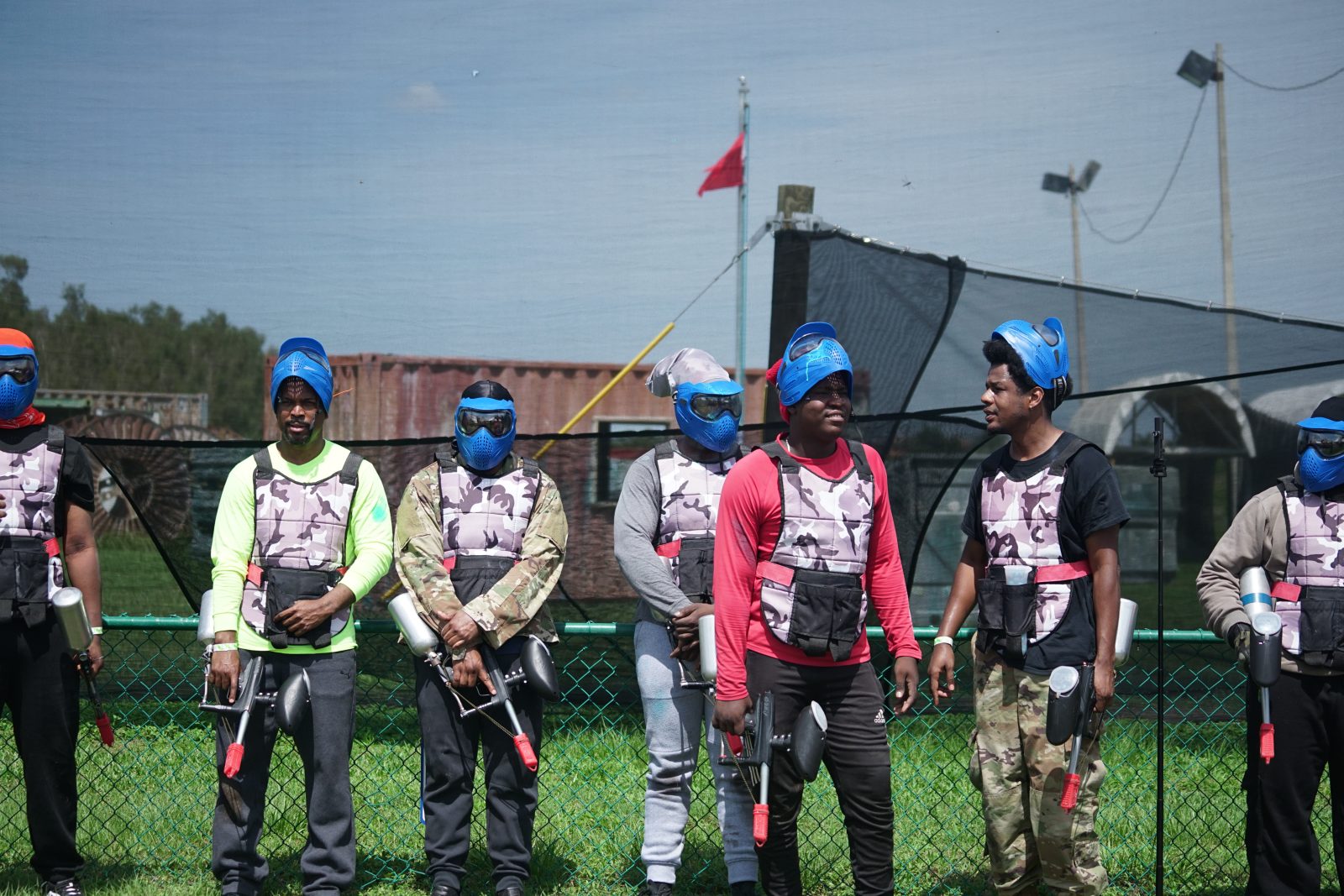 Paintball team in matching blue masks ready to play at Fort Myers Paintball Park